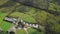 Ireland aerogenerator windmill hyperlapse aerial view. Wind turbine on green valley with solar panel