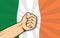 Ireland europe country fight protest symbol with strong hand and flag as background