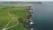 Ireland farmland, ocean bay aerial view: rocky shore of Antrim County. Epic Irish landmark landscape