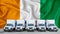 Ireland flag in the background. Five new white trucks are parked in the parking lot. Truck, transport, freight transport. Freight