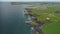 Ireland green rock shore aerial panoramic view of Antrim County Bay. Picturesque farmlands