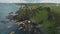 Ireland medieval Dunluce castle aerial view on cliff in Antrim County. Picturesque green landscape