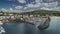 Ireland pier ocean timelapse aerial view with beautiful yachts, sailboats on sky with fluffy clouds