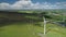 Ireland wind turbine spin aerial view: solar panels on green valley. Beautiful Ballycastle landscape