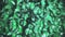 Iridescent metallic vibrant dark green color surface with motion ripples. Concept liquid pattern holographic background