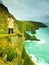 Irish atlantic coast. Woman tourist standing on rock cliff