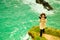 Irish atlantic coast. Woman tourist standing on rock cliff