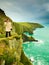 Irish atlantic coast. Woman tourist standing on rock cliff