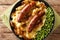 Irish Bangers and Mash is a dish consisting of sausages served with mashed potatoes and onion gravy closeup in the plate.