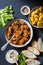 Irish beef stew and turmeric potatoes - delicious seasonal lunch on a dark background, top view.