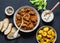 Irish beef stew and turmeric potatoes - delicious seasonal lunch on a dark background, top view. Flat lay.