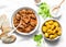 Irish beef stew and turmeric potatoes - delicious seasonal lunch on a light background, top view.