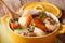 Irish coddle with pork sausage, bacon and vegetables close-up.