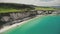 Irish emerald ocean shore aerial view: White Rock Beach washed by turquoise waves. Beautiful nature