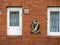 Irish harp emblem and sign Eire on a red brick wall of a building. National symbol of Ireland. Expression of national pride