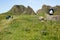 Irish landscape, green grass and cave-like rock formations, hiking family