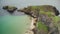 Irish ocean aerial view: tourists walk on rope bridge, Carrick Island, Northern Ireland