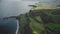 Irish ocean farmland timelapse aerial view: nature, green hills, fields. Carrick-a-Rede rope bridge