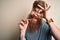 Irish redhead man with beard holding dental invisible aligner for tooth correction with happy face smiling doing ok sign with hand