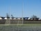 Irish sport training ground with tall goal posts for camogie, Gaelic football and rugby on a cold winter day. Frost on the green