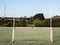 Irish sport training ground with tall goal posts for camogie, Gaelic football and rugby on a cold winter day. Frost on the green