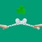 Irish traditional sport minimal concept. Man hands hold criss-crossed two hurly sticks â€“ hurleys in white color with shamrock