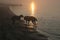 Irish Wolfhound and Scottish Deerhound seen as silhouettes at a beach in morning light