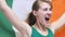 Irish Young Woman Celebrates holding the Flag of Ireland in Slow Motion