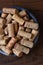 IRIVNE, CALIFORNIA - 26 JAN 2020: High angle closeup of a group of branded wine corks in a bowl from domestic and foreign wineries