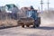 Irkutsk, Russia - April 22, 2020: An excavator rides along a dusty road.