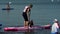 Irkutsk, Russia - August 3 2019: Baikal Jet Fest, BJF. Athlete and dog up paddleboard sup holding paddle board up