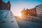 Iron arch bridges in historical warehouses in Speicherstad district in Hamburg, Germany. Backlit sun light flares