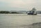 Iron barge and pusher tug boat on River. Large cargo barge transporting iron to main harbor for exporting along river.