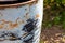 Iron barrel white shabby chipped off paint rusty weathered shabby black spots grunge style