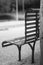 An iron bench , empty and in black and white