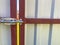 Iron bolt for closing the gate on a fence or garage. A latch for closing doors made of metal corrugated board. The background