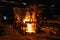 Iron casting. Molten metal pouring from blast furnace into ladle. Steel production in foundry workshop. Metallurgical