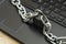 an iron chain fastened with a padlock on a computer keyboard the concept of data protection censorship on the Internet