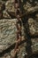 Iron chain stuck in a stone brick wall