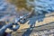 Iron chain in water on the rocky coast close up.