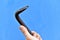Iron claw hammer in hand on a blue background