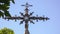 Iron cross with baroque ornaments seen from below, Spain