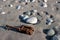 Iron debris on stones and sand near the sea