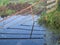 Iron fence and it`s reflection in a ditch