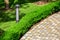 Iron ground lantern lighting a stone tile path.