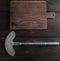 Iron hatchet for cutting meat or vegetables and brown wooden cutting board