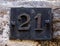 Iron house number plaque with the number 21