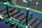 Iron joint point of ropes in children spider web with screw. Detail of cross green ropes in safety climbing outdoor equipment.