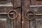 Iron knobs on old wooden gate, background.