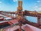 Iron ore conveyor loading cargo in the bulk carrier with a cloudy blue sky in the background